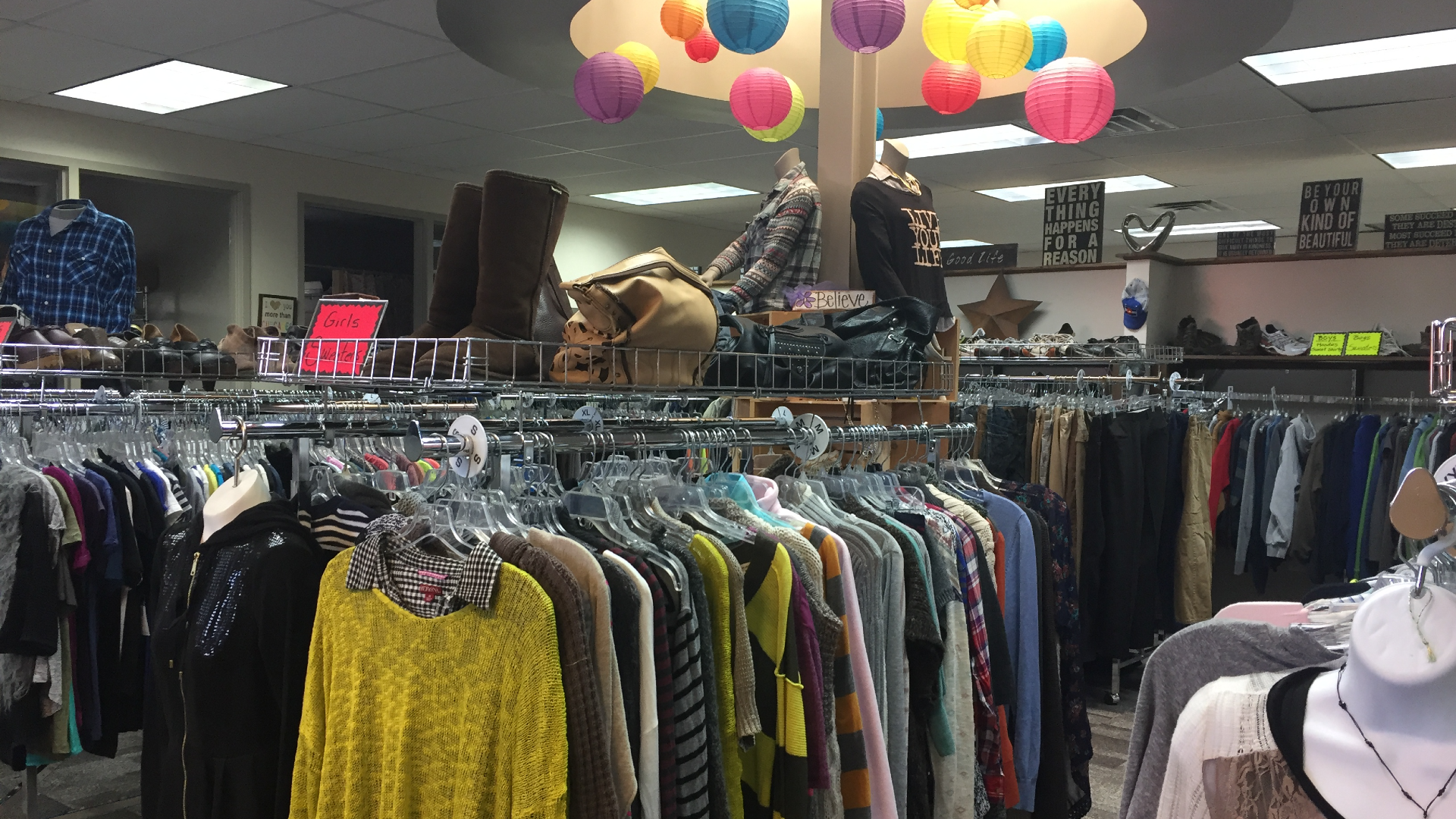 Clothing hanging on racks in a store