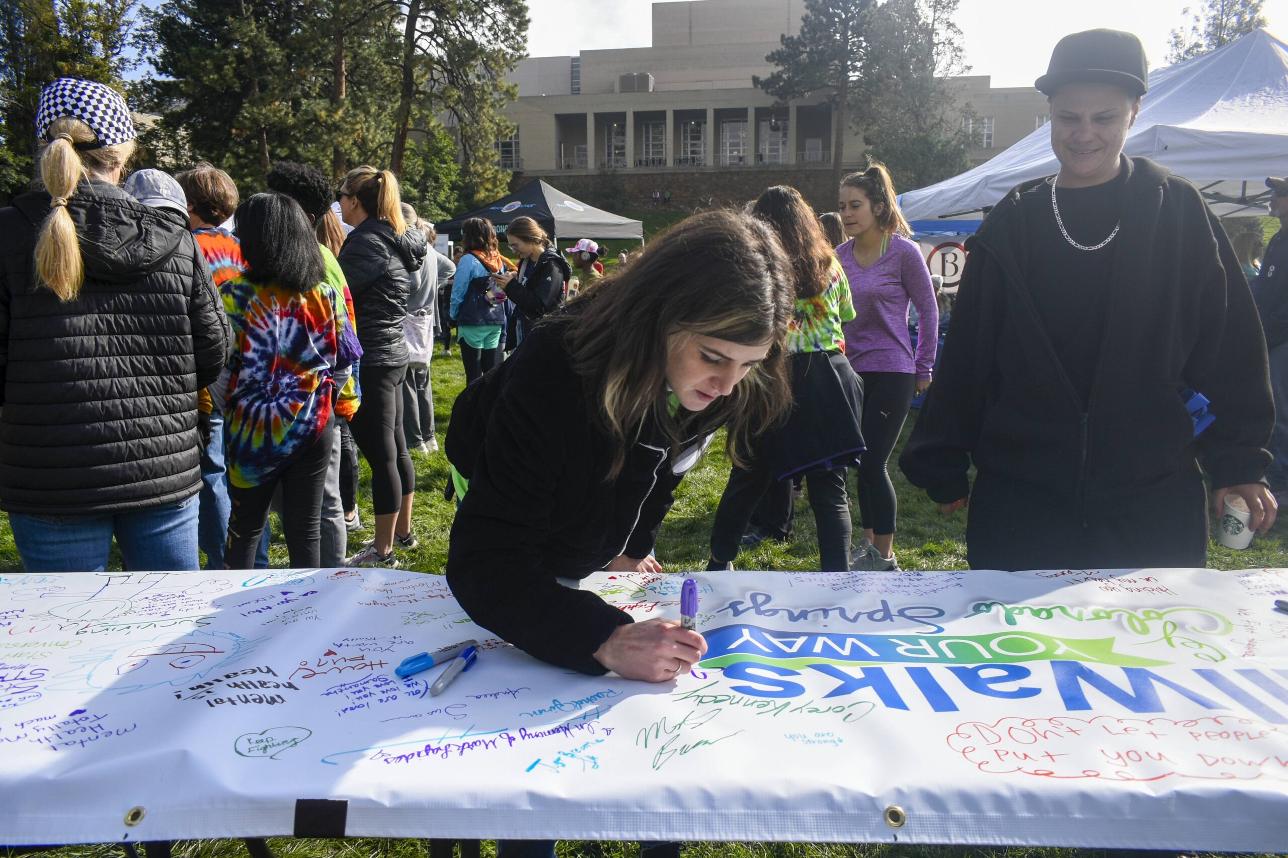 Woman signing banner at community event