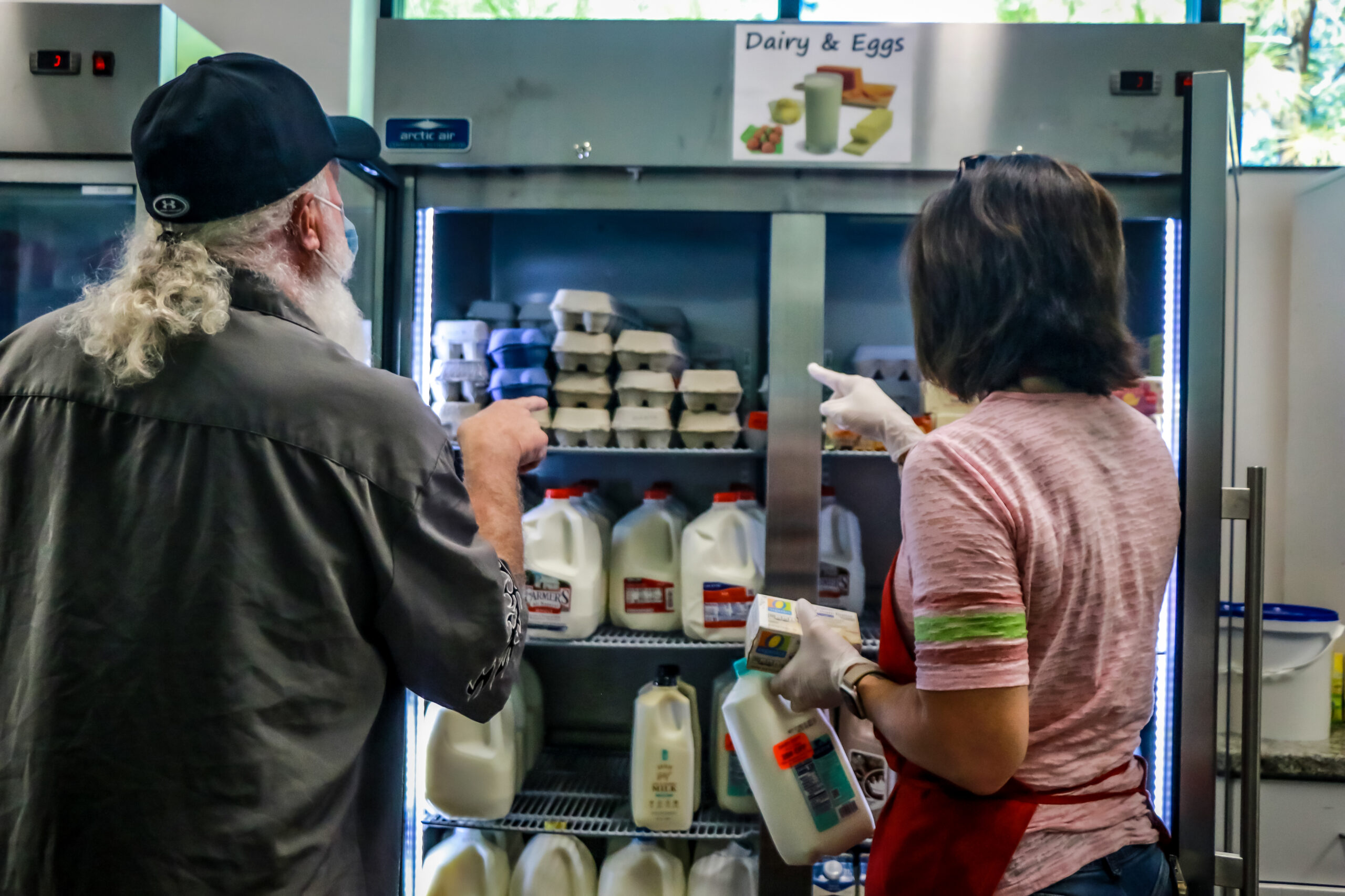 Man and woman shopping for milk and eggs