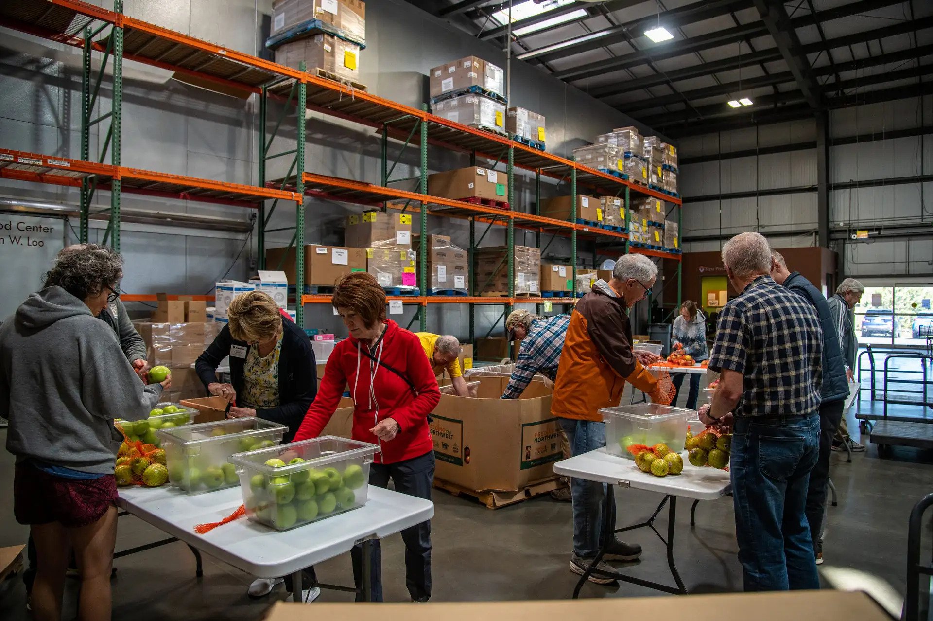 Workers sorting food in warehouse